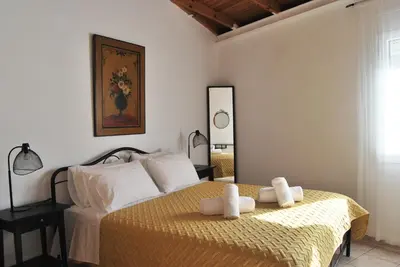 a bedroom with a bed with two towels on it at Chrysiida Suites in Tersanas