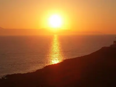 an image of the sun setting over the ocean at Chrysiida Suites in Tersanas