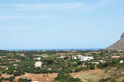 a view of a city from the top of a hill at Chrysiida Suites in Tersanas