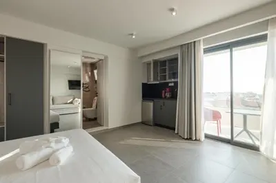 a hotel room with a bed and a balcony at Sky-High Central Penthouse w. Stunning Views - 03 in Chania Town