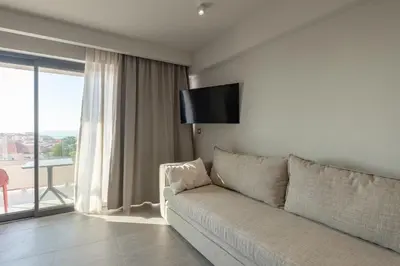 a living room with a couch and a large window at Sky-High Central Penthouse w. Stunning Views - 03 in Chania Town