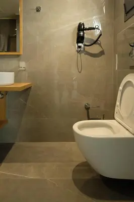 a bathroom with a toilet and a phone on the wall at Sky-High Central Penthouse w. Stunning Views - 03 in Chania Town
