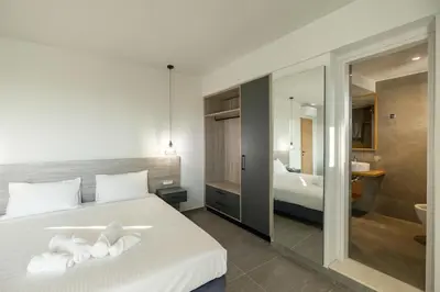 a hotel room with a bed and a bathroom at Sky-High Central Penthouse w. Stunning Views - 03 in Chania Town