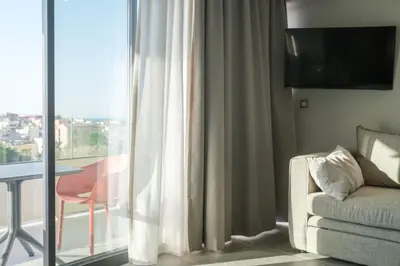 a living room with a couch and a glass window at Sky-High Central Penthouse w. Stunning Views - 03 in Chania Town
