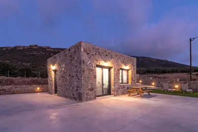 a stone house with a picnic table in front of it at The Rock *Peaceful Retreat House in Kámbos