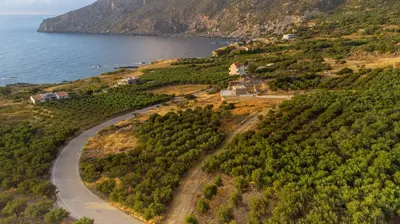 an aerial view of a road on a hill next to the ocean at The Rock *Peaceful Retreat House in Kámbos
