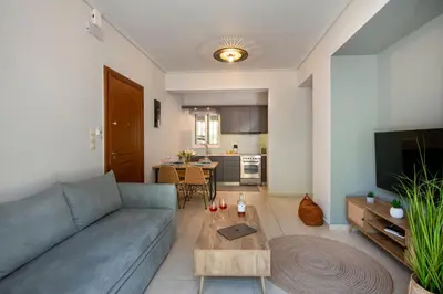 a living room with a blue couch and a table at Inner City Retreat Apartment in Chania Town