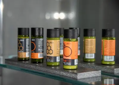 a row of bottles of oils sitting on a shelf at Inner City Retreat Apartment in Chania Town