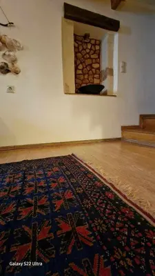 a room with a rug on the floor and a wall at Traditional 3 Story Townhouse ,Batta Hanem in Chania Town