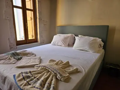 a bedroom with a bed with towels on it at Traditional 3 Story Townhouse ,Batta Hanem in Chania Town