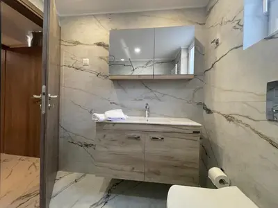 a bathroom with a sink and a mirror at SK Luxury Residence in Chania Town