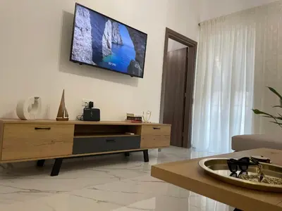 a living room with a flat screen tv on the wall at SK Luxury Residence in Chania Town