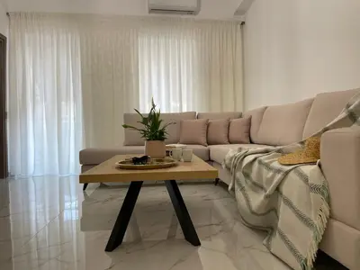 a living room with a couch and a coffee table at SK Luxury Residence in Chania Town