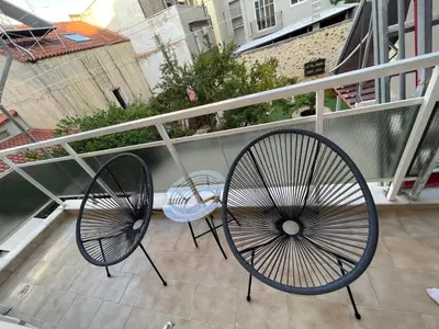 two chairs and a table on a balcony at SK Luxury Residence in Chania Town