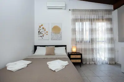 a bedroom with a bed with towels on it at En Plo Beachfront Rooms in Falasarna