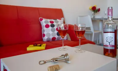 a bottle of wine and two glasses on a table at Casa Di Halepa in Chania Town