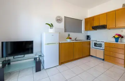 a kitchen with a white refrigerator and a tv at Casa Di Halepa in Chania Town