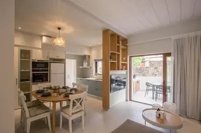a kitchen and dining room with a table and chairs at Villa Methexis in Arménoi