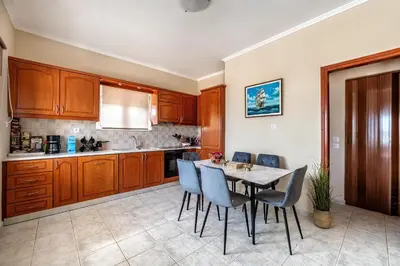 a kitchen with a table and chairs in a room at House On The Beach In Kera - BY APOKORONAS VILLAS in Kalyves