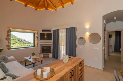 a living room with a couch and a table at Place of the Gοds in Palaiochóra