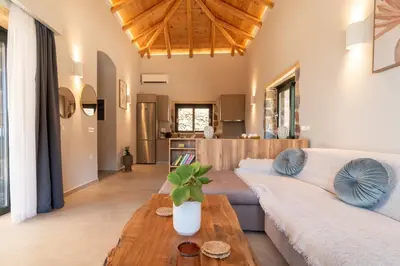 a living room with a couch and a table at Place of the Gοds in Palaiochóra