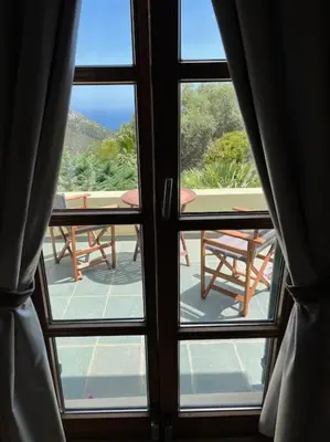a view from a window of a patio with a table at Staffed, unique and luxurious coastal villa in beautiful Anidri, Paleochora in Palaiochóra