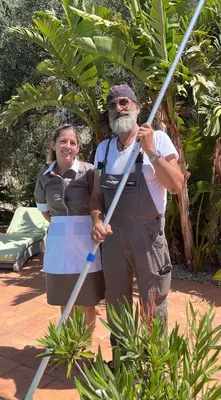 a man and a woman holding two baseball bats at Staffed, unique and luxurious coastal villa in beautiful Anidri, Paleochora in Palaiochóra