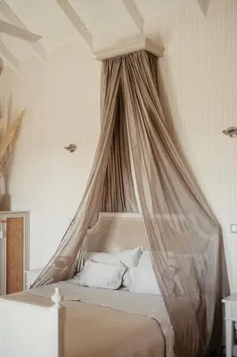 a bed with a canopy in a bedroom at Staffed, unique and luxurious coastal villa in beautiful Anidri, Paleochora in Palaiochóra