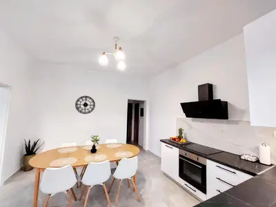 a kitchen and dining room with a wooden table and chairs at Blue Horizon Kissamos Apartment in Kissamos
