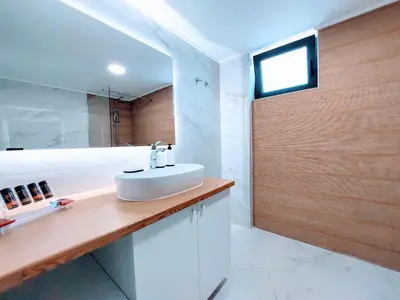 a bathroom with a white sink and a shower at Blue Horizon Kissamos Apartment in Kissamos