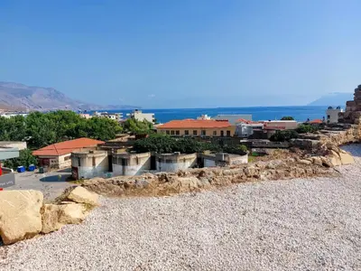 a group of buildings on a rocky beach at Blue Horizon Kissamos Apartment in Kissamos