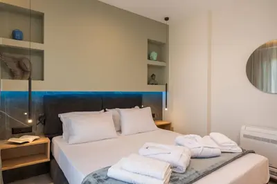 a bedroom with a bed with towels on it at Aspect Luxury Apartments with Pool in Galangádhos