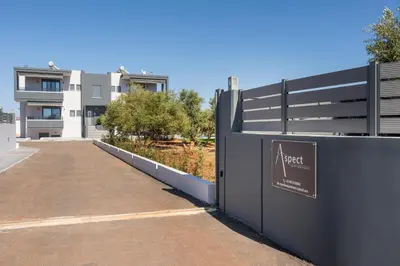 a fence with a sign on it next to a building at Aspect Luxury Apartments with Pool in Galangádhos