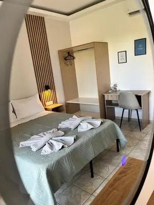 a bedroom with a bed with towels on it at Dream Apartments in Palaiochóra