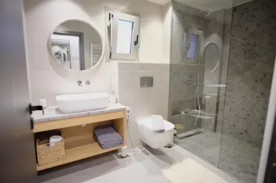 a bathroom with a toilet and a sink and a shower at GREEN ESTATE villas in Arménoi