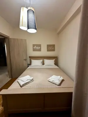 a bed in a room with two towels on it at Maria's Cozy Chania Apartment in Chania Town