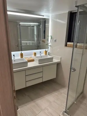 a bathroom with two sinks and a shower at Maria's Cozy Chania Apartment in Chania Town
