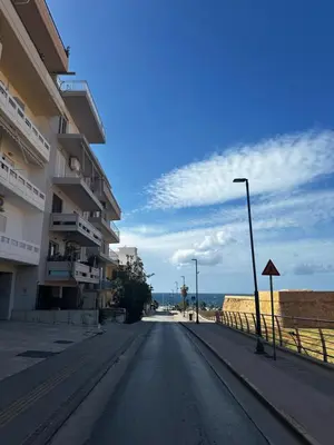an empty street with buildings and a street light at Maria's Cozy Chania Apartment in Chania Town
