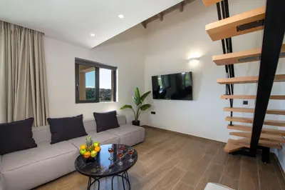 a living room with a couch and a table at Armour Eclectic Villa in Afráta