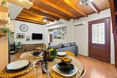 a living room with a table and a couch at Rodon maisonette in Chania Town