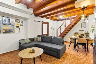 a living room with a couch and a table at Rodon maisonette in Chania Town