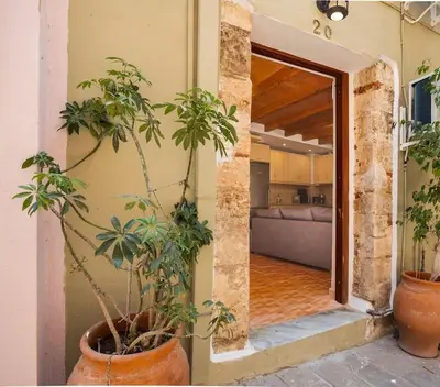 a hallway with potted plants and a living room at Rodon maisonette in Chania Town