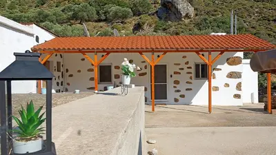 a building with a pavilion with a vase of flowers at Polyraki's Cottage in Chania Town
