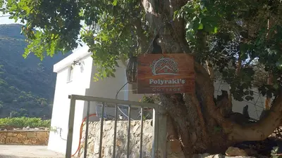 a sign on a tree next to a gate at Polyraki's Cottage in Chania Town