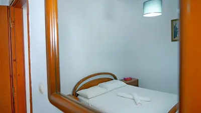 a reflection of a bed in a mirror at Polyraki's Cottage in Chania Town