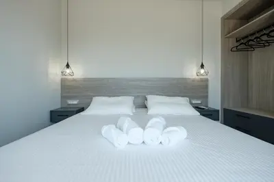a bedroom with a white bed with two white pillows at Sky-High Central Penthouse w. Stunning Views - 02 in Chania Town