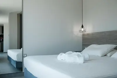 a bedroom with two beds with white sheets at Sky-High Central Penthouse w. Stunning Views - 02 in Chania Town