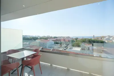 a balcony with a table and chairs and a large window at Sky-High 70sqm Penthouse w. Stunning Views - 05 in Chania Town