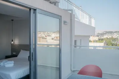 a bedroom with a view of a bed and a balcony at Sky-High 70sqm Penthouse w. Stunning Views - 05 in Chania Town