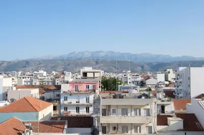 a city with buildings and mountains in the background at Sky-High 70sqm Penthouse w. Stunning Views - 05 in Chania Town